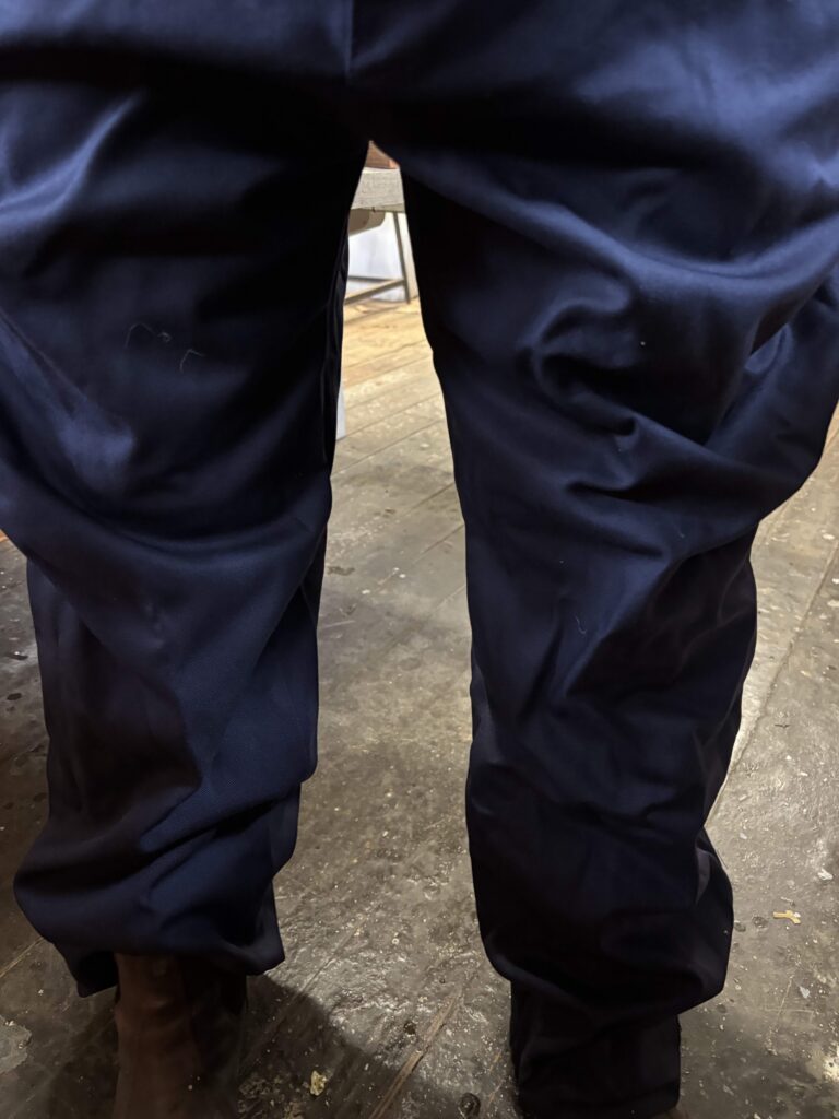 PPE trousers shown on boatbuilder - enormously baggy for a woman