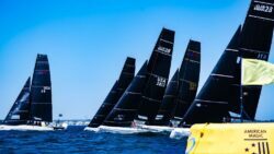 Elite sailing race on the water. with black sails