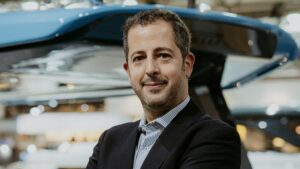 man smile at camera in suit and shirt