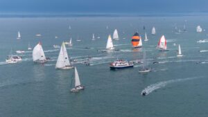 flotilla of sail boats in calm water at start of Ocean Globe Race