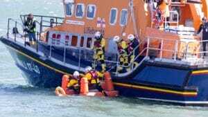 Mass rescue training event in Poole Bay, Dorset on 20the April 2023. Mass simulation event testing of self rescue equipment during a mass rescue in response to the rescue of migrants crossing the English Channel. RNLI lifeguards acted as casualties and were rescued by volunteer crew members by a Shannon, Severn and Atlantic 85 B-class inshore lifeboat.