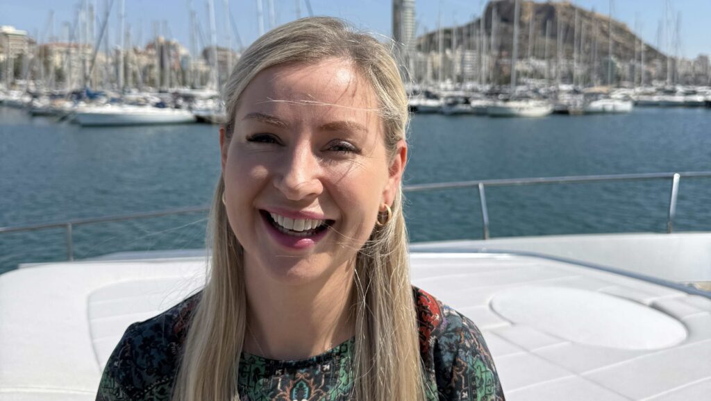 Fiona Richardson smiles at camera. She's on a boat