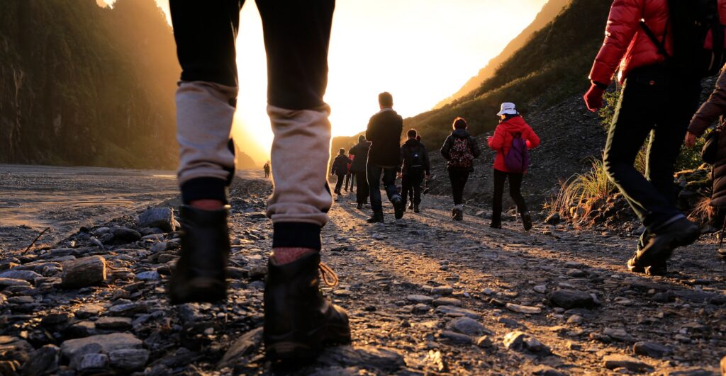 Feet of a group of people walking on a trail