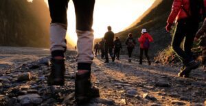 Feet of a group of people walking on a trail