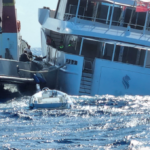 tug attaches lines to motor yacht which then sinks off Italy coastline
