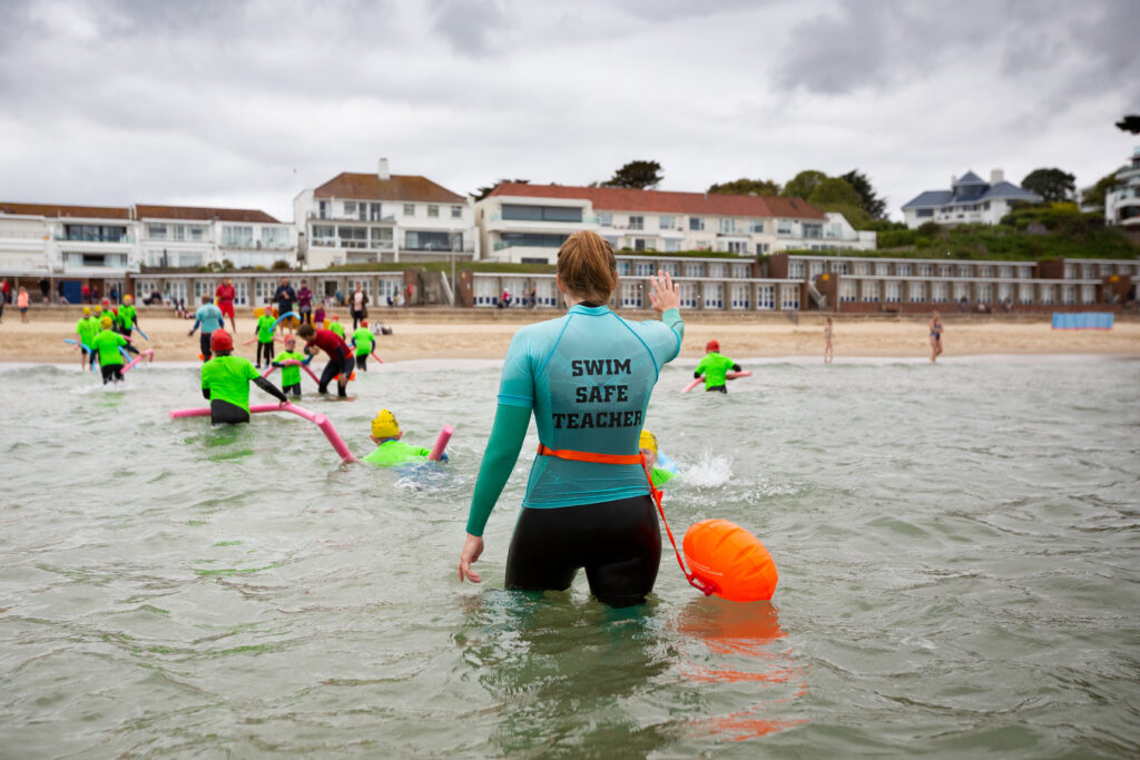 instructor leading a swim safe session on a beach