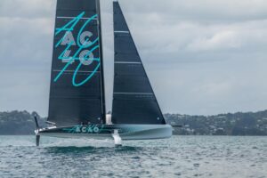 AC40 America's Cup boat foiling at speed through the water.