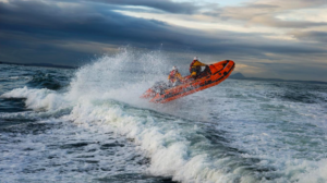 RNLI lifeboat skimming waves in stormy seas