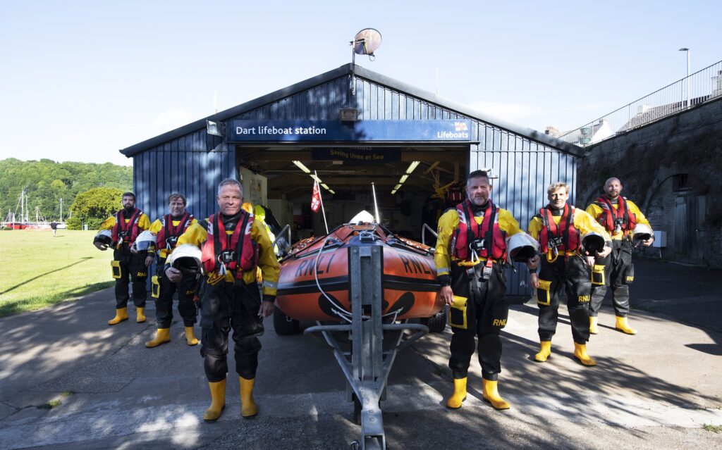 Dart lifeboat crew outside the current temporary station Credit: RNLI