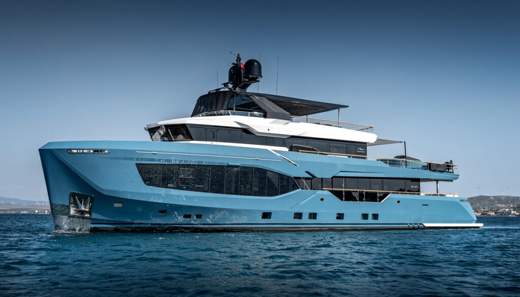 Large blue hulled superyacht with white superstructure