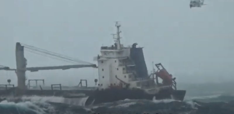 Freighter in violent seas aground on coral reef