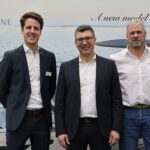 Greenline CEO Matjaz Grm and team in front of Greenline Yachts logo