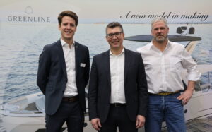 Greenline CEO Matjaz Grm and team in front of Greenline Yachts logo