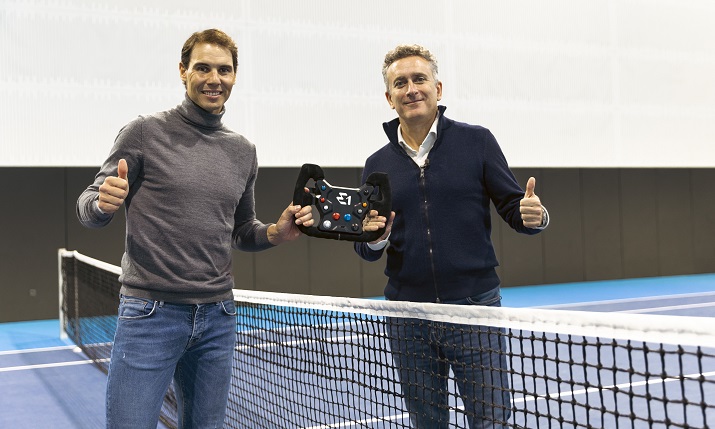 Rafael Nadal and E1 Co-Founder & Chairman Alejandro Agag stood together on the tennis court, holding the steering wheel used in the electric raceboat.