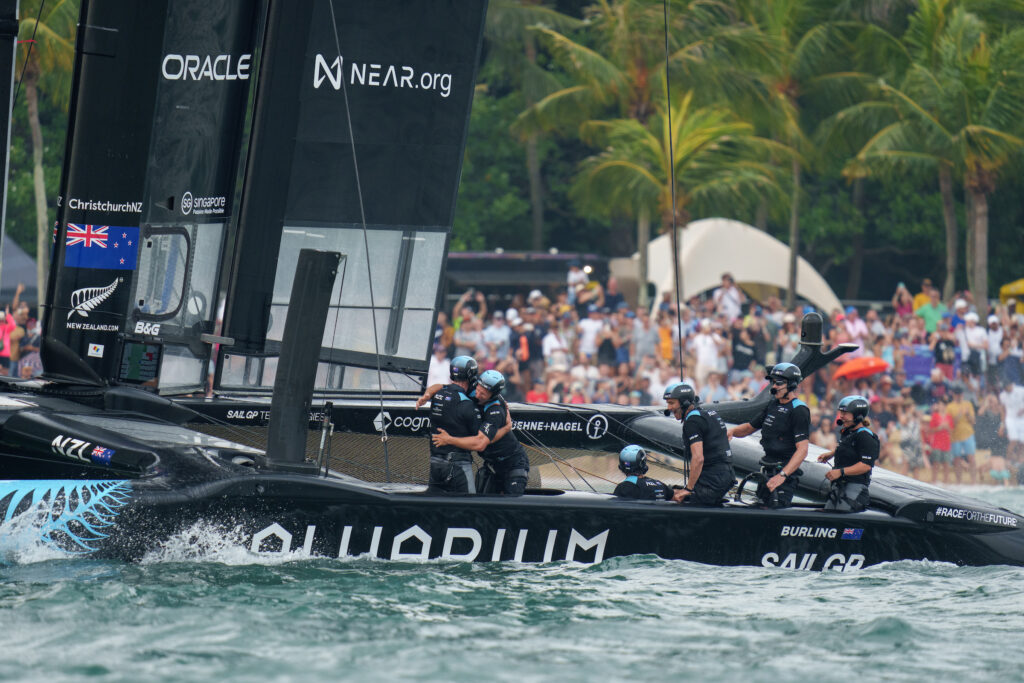 New Zealand SailGP crew celebrate as tgheuy cross the finish line to win the final race on Race Day 2 of the Singapore Sail Grand Prix presented by the Singapore Tourism Board in Singapore, Singapore. 15th January 2023. Photo: Bob Martin for SailGP. Handout image supplied by SailGP