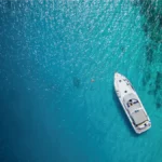 birds eye view of motorboat at anchor in tropical seas