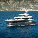 Superyacht underway of mountainous coast