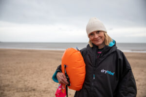Blond woman Louise Minchin by the sea in winter