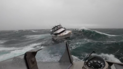 Motor boat lists in heavy sea during US Coast Guard rescue