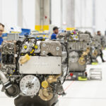 Man in factory by Rolls-Royce's Power Systems engine