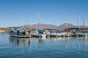 Boats moored on pontoons with mountain backdrop
