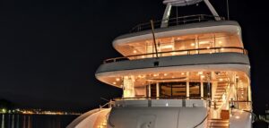 Stern of a superyacht at night lit up