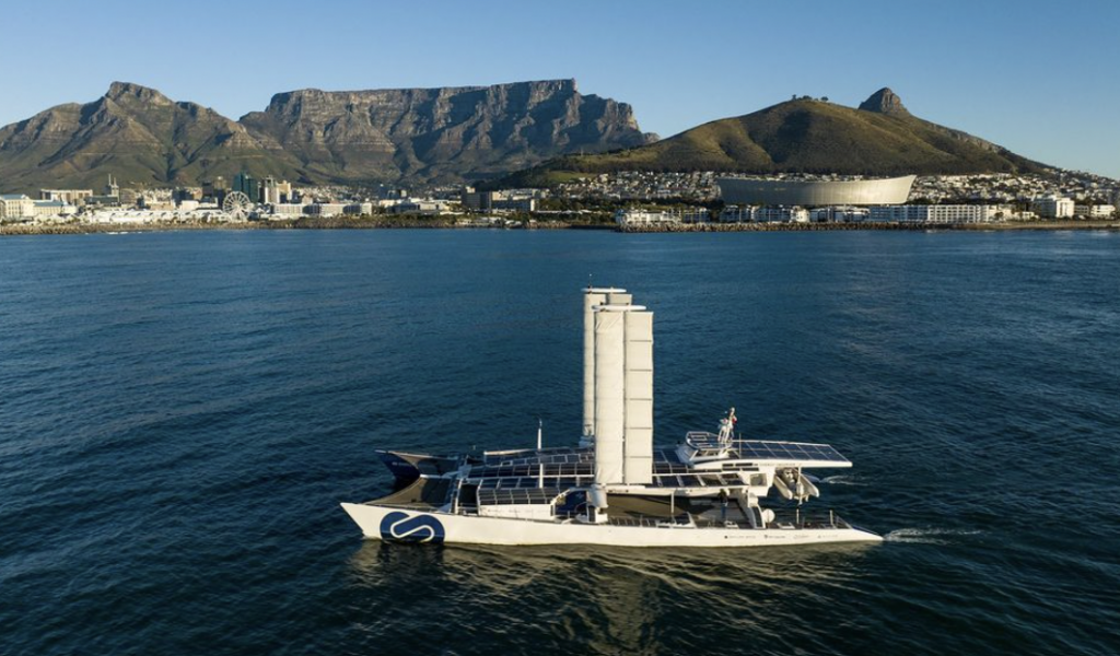 Catamaran Energy Observer sailing past Table Mountain in Cape Town