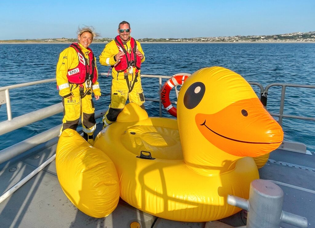 Two RNLI volunteers with giant inflatable duck