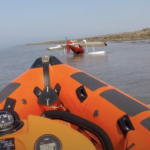 Small plane in sea with lifeboat