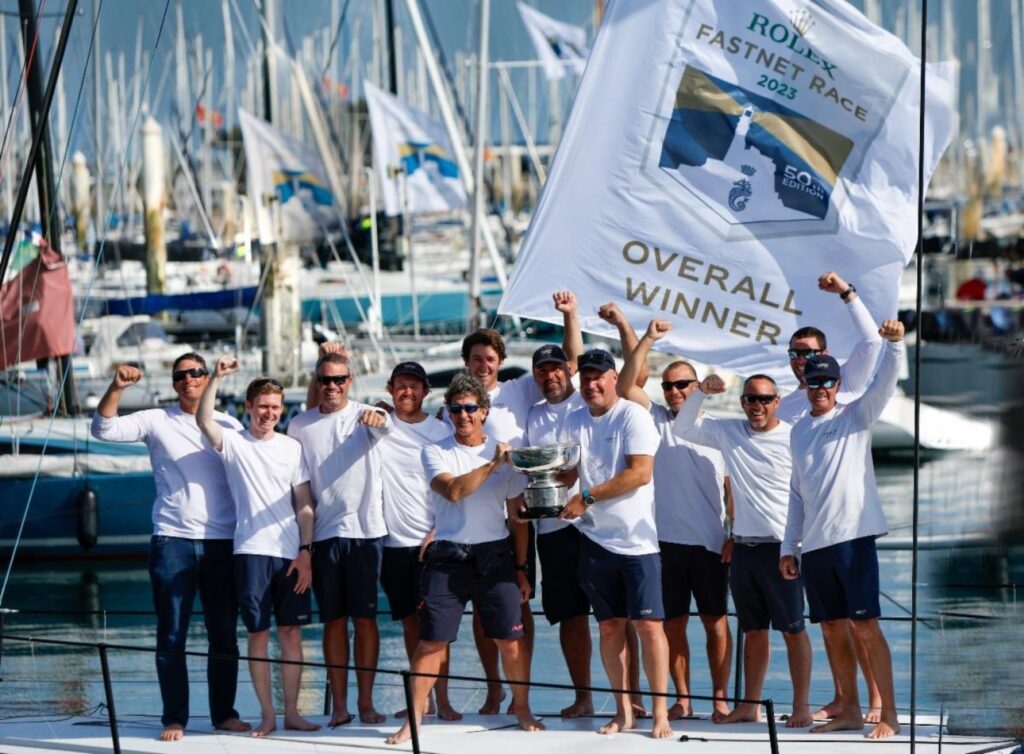 Max Klink (right) and tactician Adrian Stead (left) plus the Caro crew with the Rolex Fastnet Race overall winner's trophy - the Fastnet Challenge Cup ﻿© Paul Wyeth
