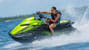 Female rider on multi-coloured personal watercraft