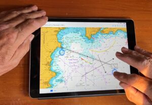 iPad being used to plot a course on a chart