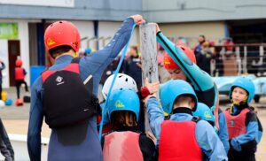 A group of young people in buoyancy aid and hard hats