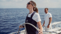 Sailor looks into distance from deck of yacht