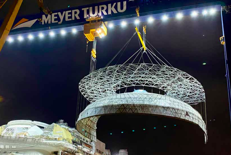 Glass dome for cruise ship being lowered into place onto Icon of the Seas