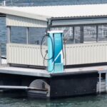 Electric charging point on floating pontoon with a ferry moored up along the opposite side.