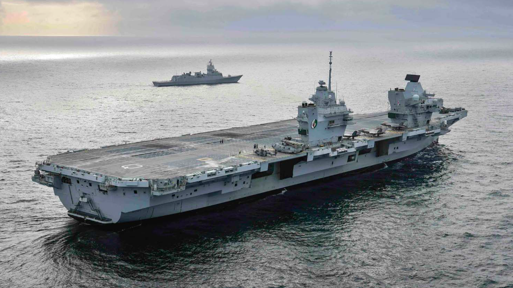 aircraft carrier at sea, in still grey water
