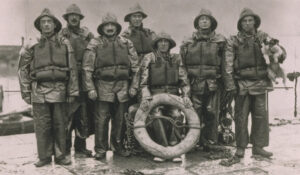 Ballycotton crew 1936. M.C. Walsh Mech. T Sliney, 2nd Cox, J.L.Walsh, J.S. Sliney. Cox Patrick Sliney, T D Walsh, W Sliney. and a dog.