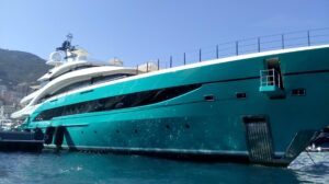 the hull of a blue superyacht