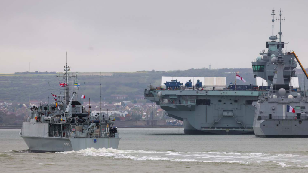 Warships in the harbour, with Portsdown Hill in the background