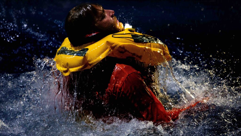 person in distres in water with a lifejacket on