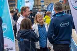 People smiling at regional boat show as they discuss what's on offer