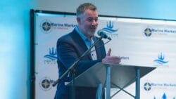 man stands at lectern