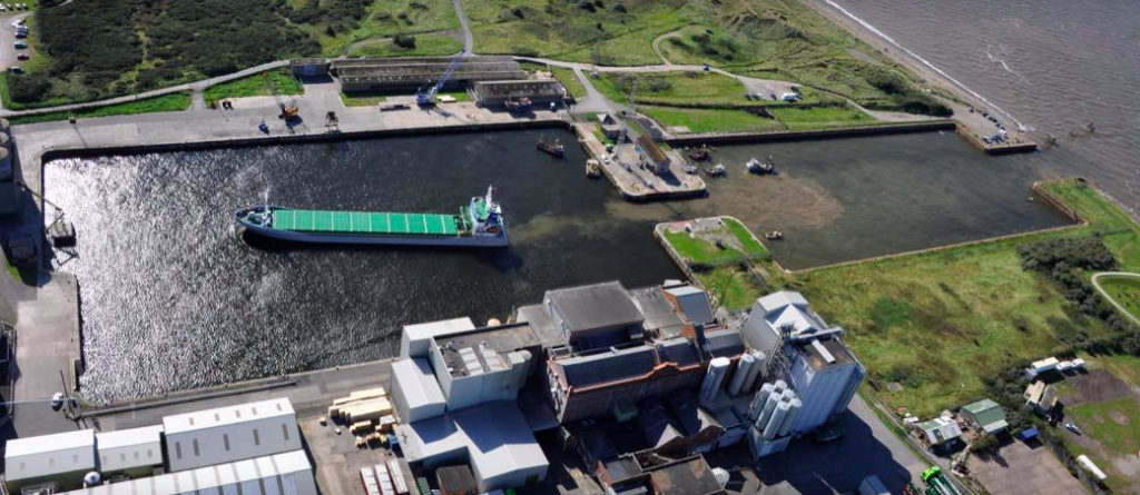 Aerial view of Port of Silloth - tanker enters harbour - but sand can be seen where cargo ship grounded recently