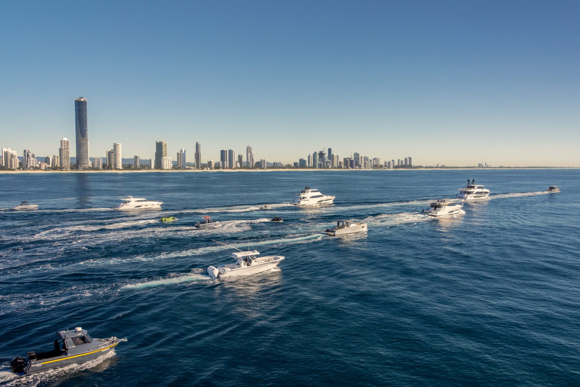 Police Boat escorting boats to the biggest party of the Year with Surfers Paradise skyline background.