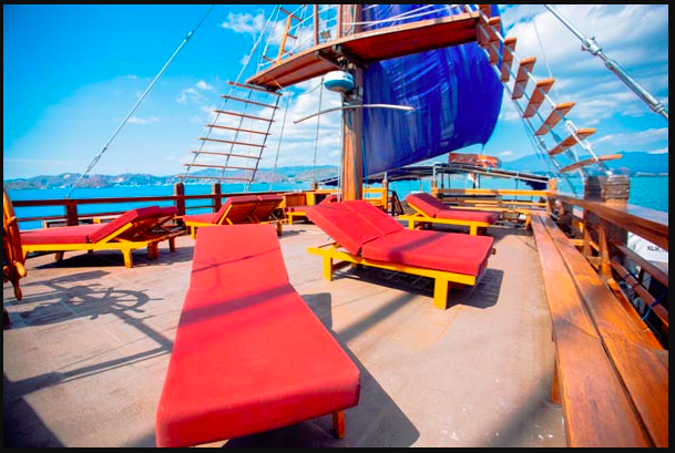 brightly coloured sun loungers on a boat deck
