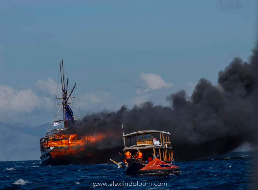 masses of smoke from dive boat as rescue boats make way to stricken vessesl