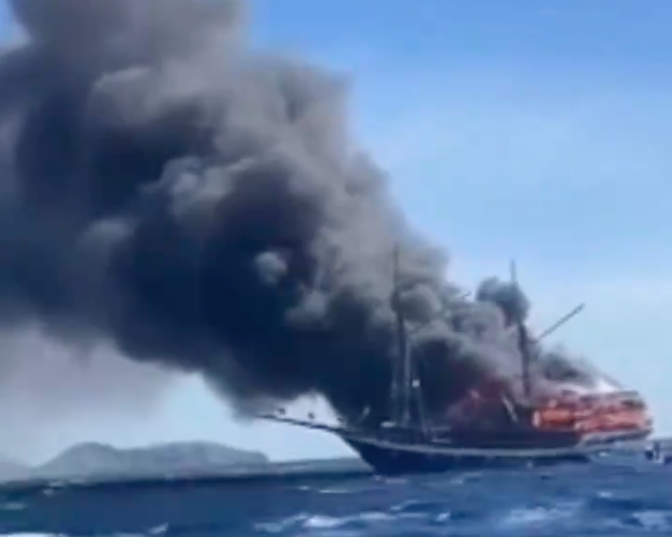 dive boat on fire with black smoke billowing
