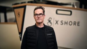 X Shore CEO Rene Hansen man standing in front of boat bow