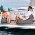 two people sat on bean bags on a boat